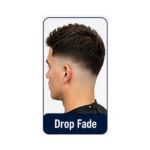 Stylish drop fade haircut curving downward behind the ears with textured hair on top.