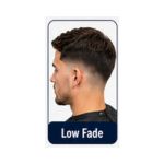 Side profile of a man with a low fade haircut blending softly above the ears with longer textured hair on top.