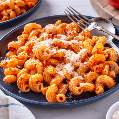 Cavatappi pasta with hollow, curved corkscrew shapes.